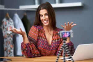 Smiling and expressive woman speaking to the camera, symbolizing the power of words in emotional expression and emotional intelligence.