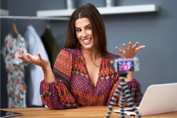 Smiling and expressive woman speaking to the camera, symbolizing the power of words in emotional expression and emotional intelligence.